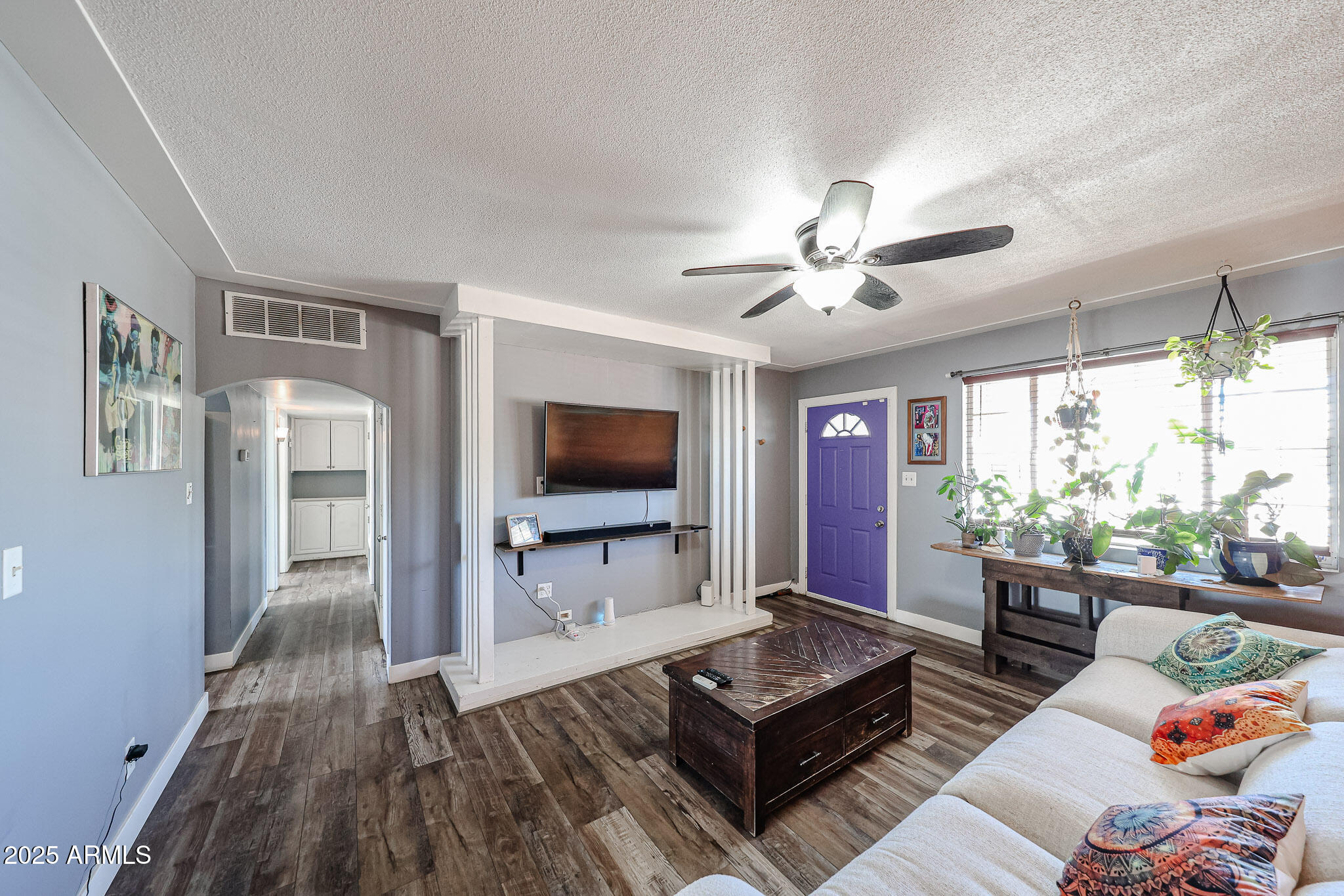 2037 West State Avenue Phoenix, AZ 85021 - Photo 3 of 18 a living room with furniture and a flat screen tv