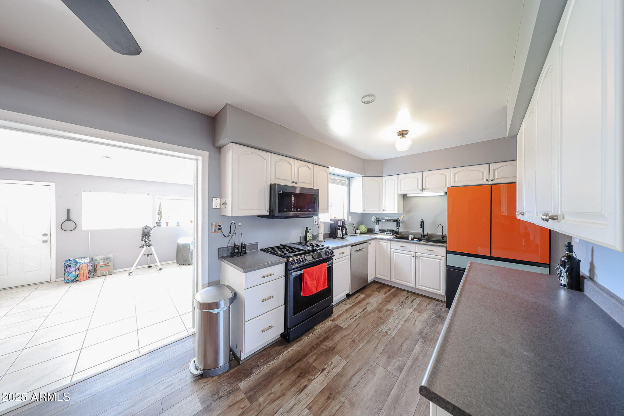2037 West State Avenue Phoenix, AZ 85021 - Photo 5 of 18 a large kitchen with cabinets wooden floor and stainless steel appliances