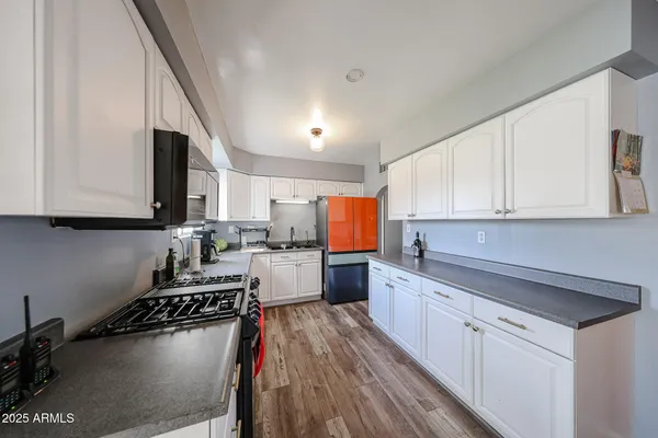 a kitchen with kitchen island granite countertop a sink cabinets and counter space