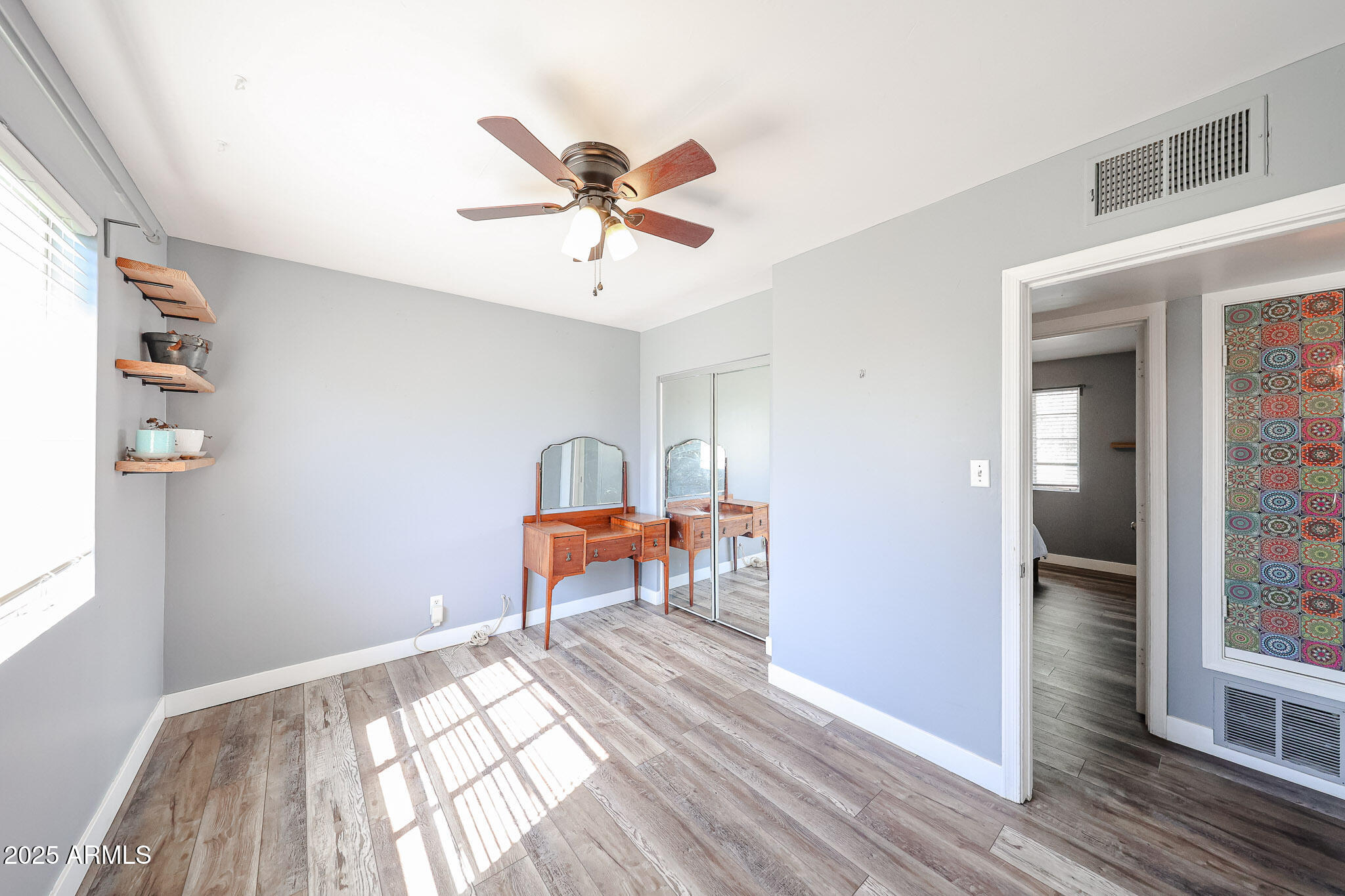 2037 West State Avenue Phoenix, AZ 85021 - Photo 10 of 18 a bedroom with a bed and a chandelier