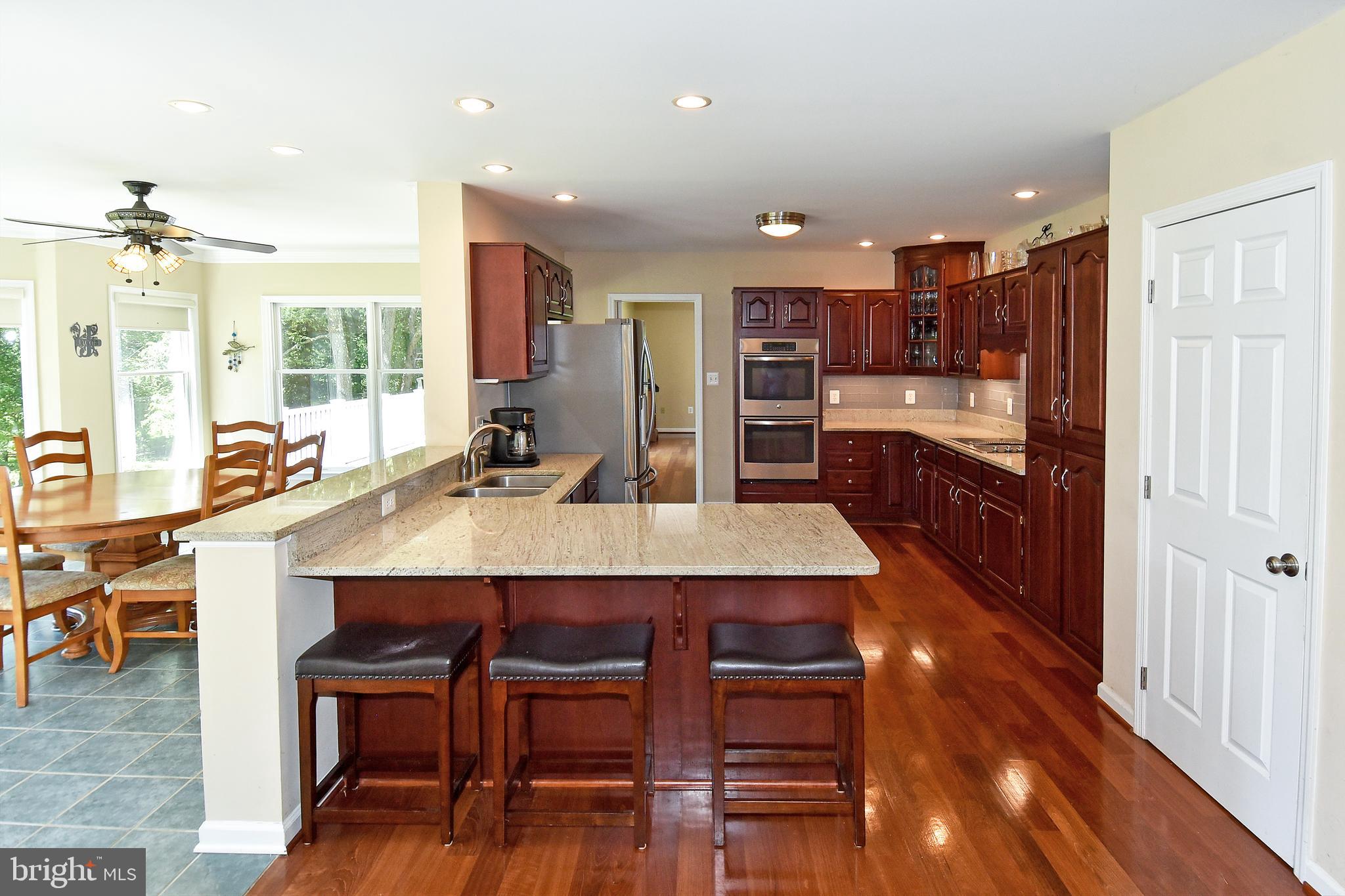 18106 Canby Road Leesburg, VA 20175 - Photo 24 of 65 Peninsula seating in Kitchen opens to Dining Room