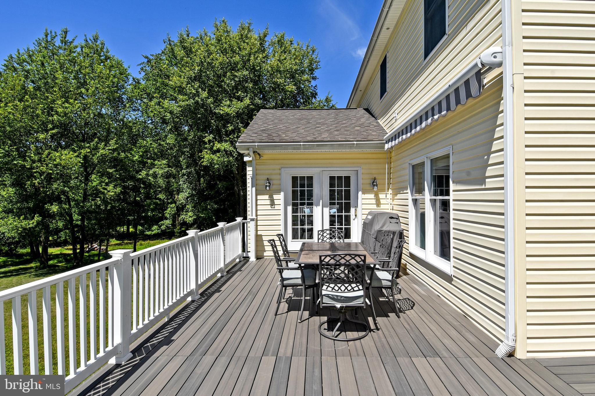 18106 Canby Road Leesburg, VA 20175 - Photo 10 of 65 TREX deck wraps around to garage and front of home
