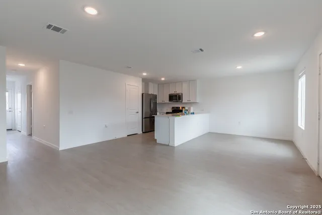 a view of a kitchen with a sink and a refrigerator
