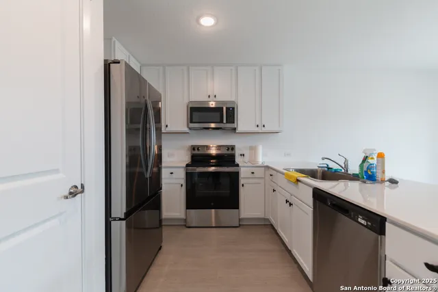a kitchen with a refrigerator stove and microwave