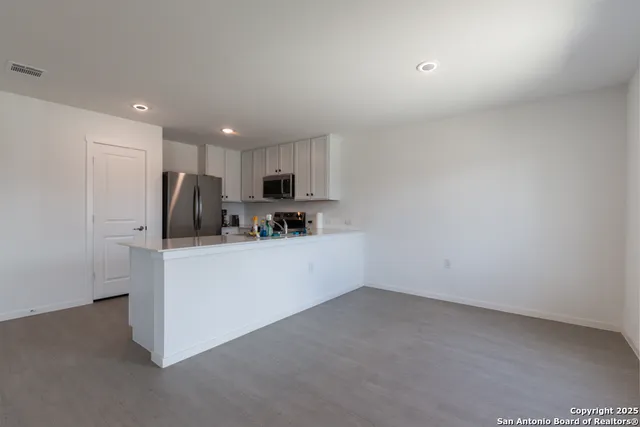 a view of cabinets with wooden floor