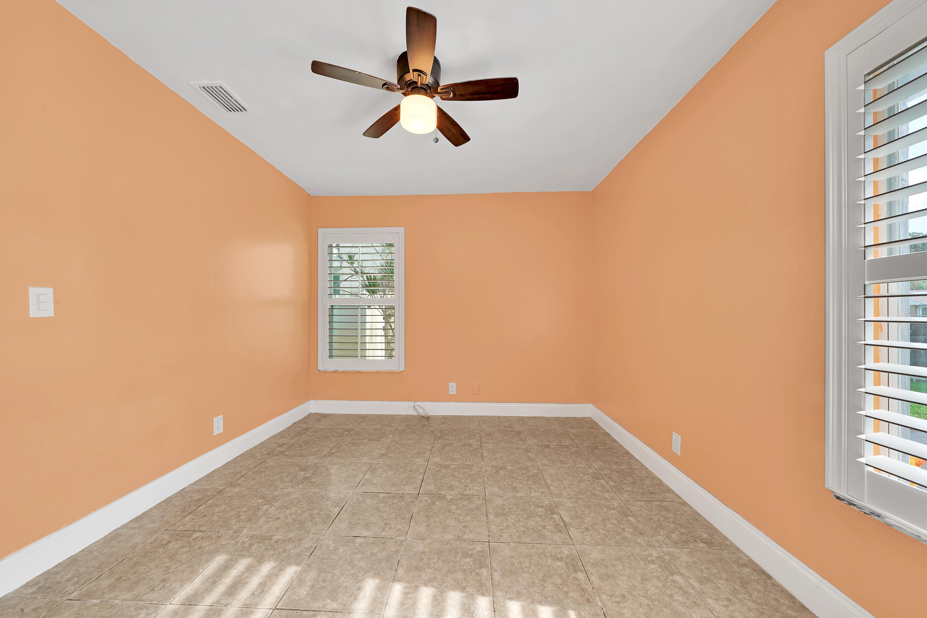 724 Ave Chaumont Delray Beach, FL 33445 - Photo 18 of 35 an empty room with windows and fan