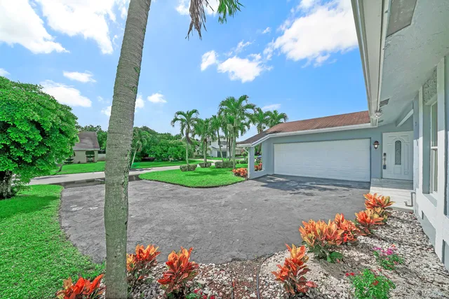 a front view of a house with a yard and a garage