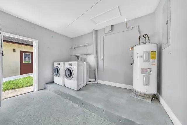 a utility room with refrigerator and washer