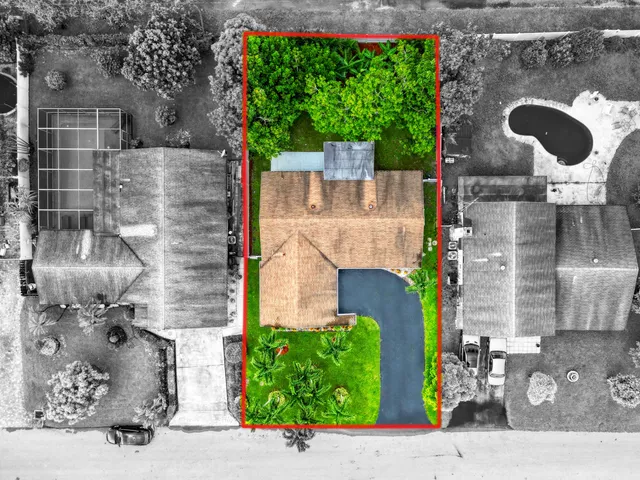 an aerial view of a house with a yard and potted plants