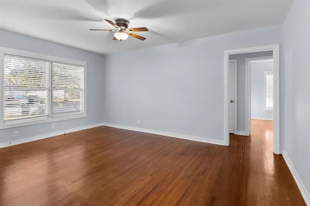 wooden floor in an empty room with a window