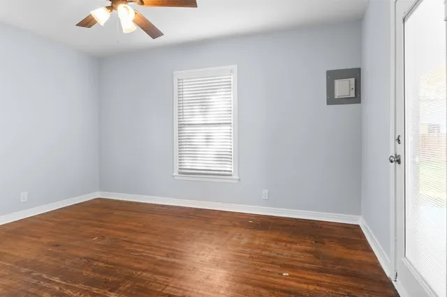 wooden floor in an empty room with a window