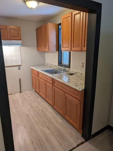a kitchen with stainless steel appliances granite countertop a sink stove and cabinets