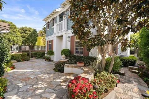 a view of backyard with outdoor seating and plants