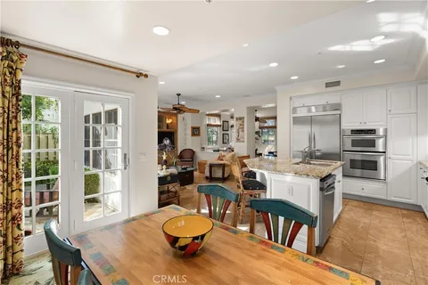 a large kitchen with a table and chairs in it