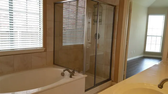 a bathroom with a bathtub and a shower