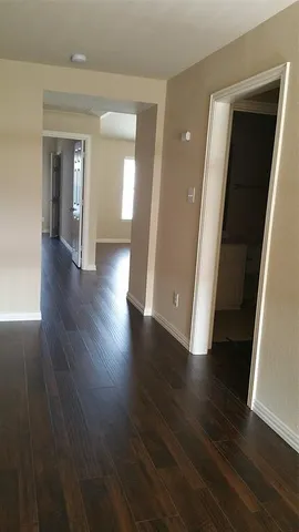 wooden floor in a hallway with a window