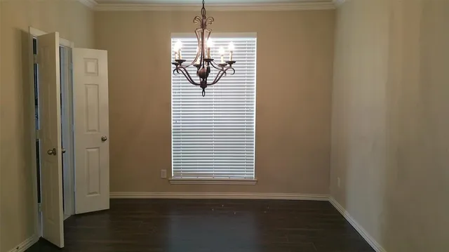 a view of a room with wooden floor closet and windows