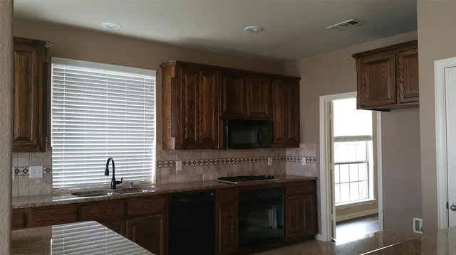 a kitchen with a sink and a window