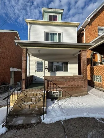 a front view of a house with parking space