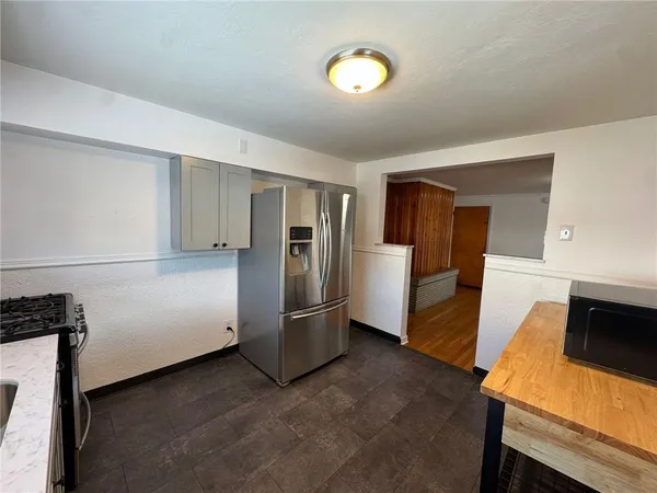 a view of kitchen with furniture and refrigerator
