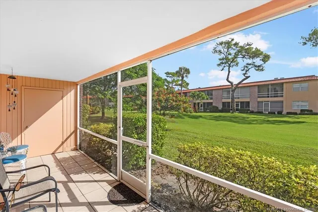 a view of an house with backyard from a balcony