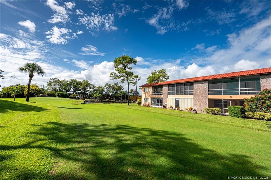1969 Southwest Palm City Road, Unit C Stuart, FL 34994 - Photo 15 of 23 a front view of a house with a garden