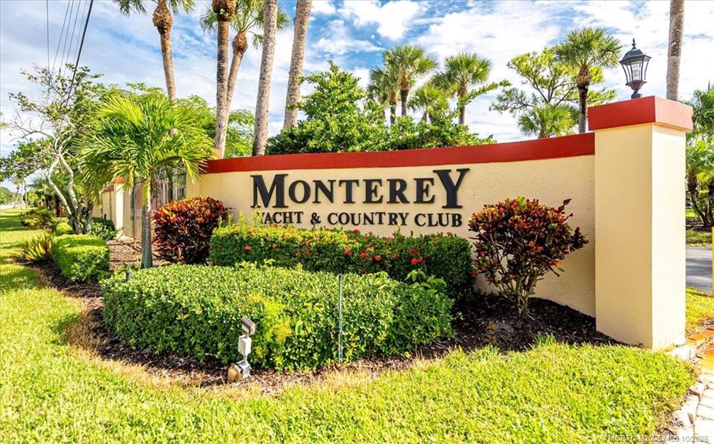 1969 Southwest Palm City Road, Unit C Stuart, FL 34994 - Photo 23 of 23 a sign that is sitting in front of flowers
