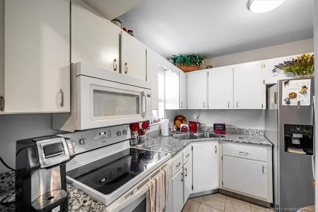 a kitchen with cabinets a washer and dryer