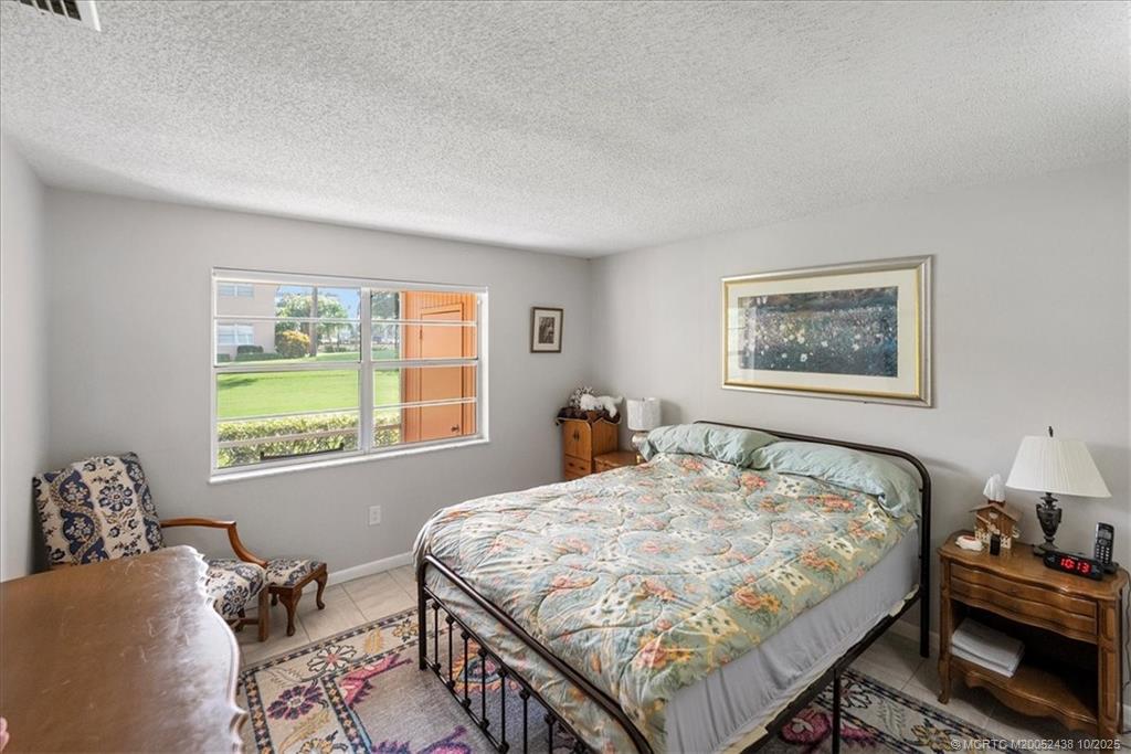 1969 Southwest Palm City Road, Unit C Stuart, FL 34994 - Photo 9 of 23 a bedroom with a bed and a window