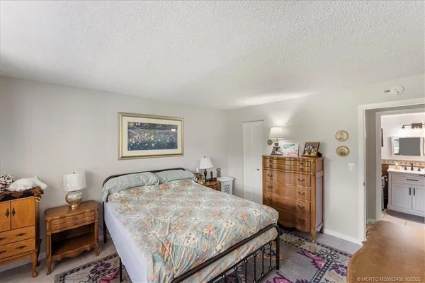 a bedroom with a bed and a dresser in it