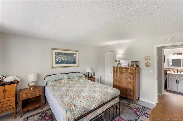 a bedroom with a bed and a dresser in it