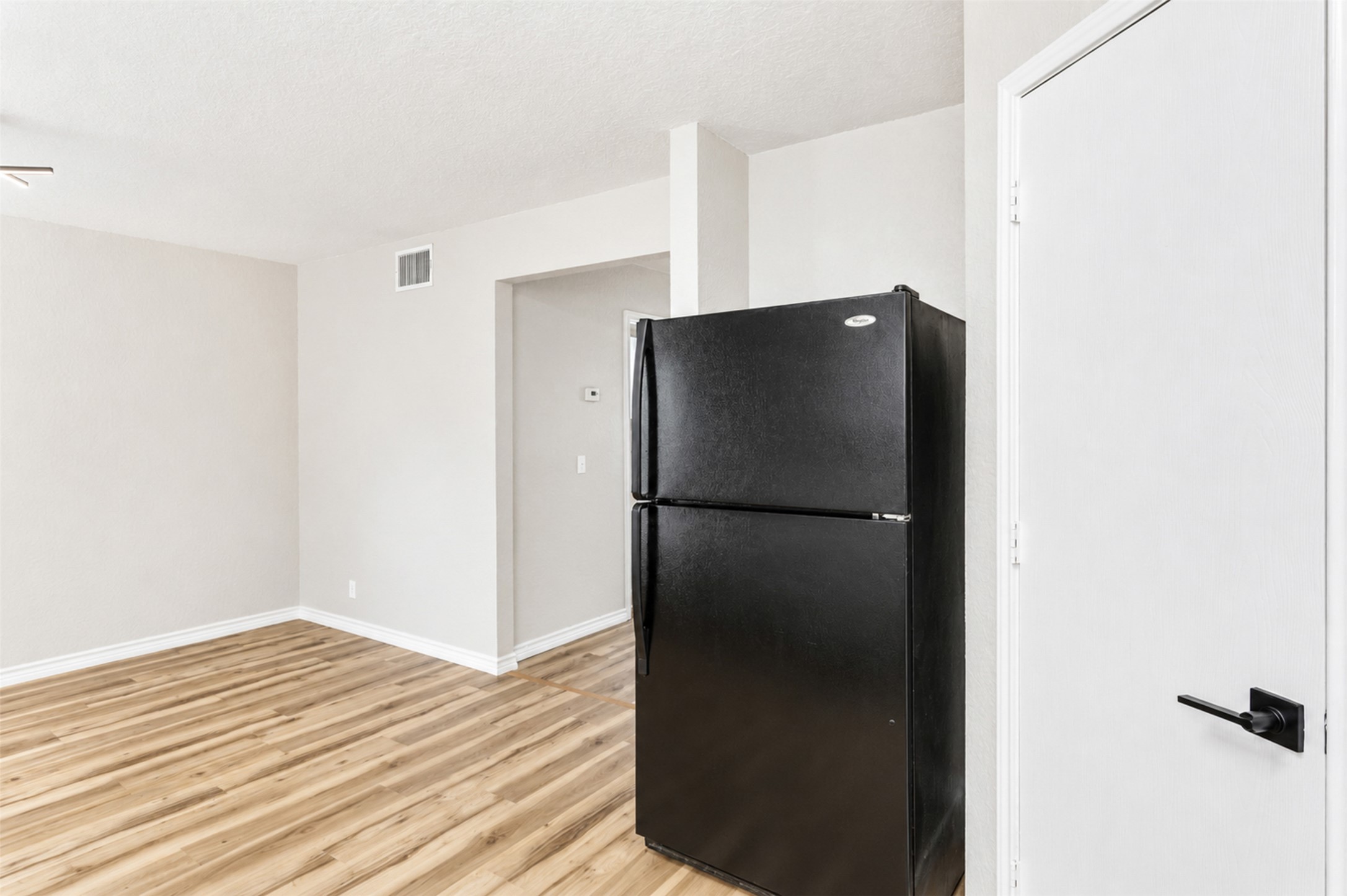 4523 Secure Lane Austin, TX 78725 - Photo 18 of 40 A well-maintained refrigerator and solid-surface flooring offer contemporary convenience.