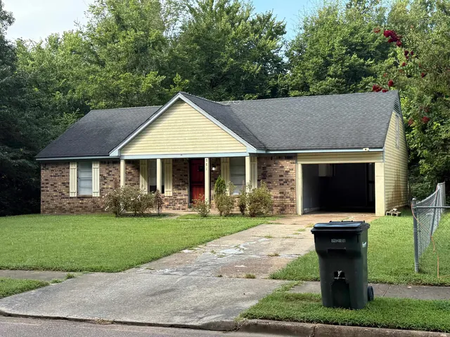 a front view of house with yard and green space