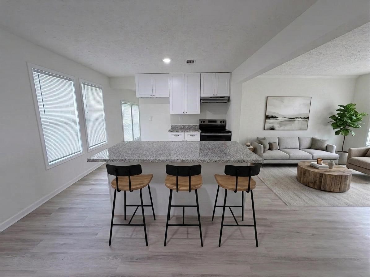 1112 3rd Street La Marque, TX 77568 - Photo 4 of 21 a kitchen with a table chairs stove and kitchen island