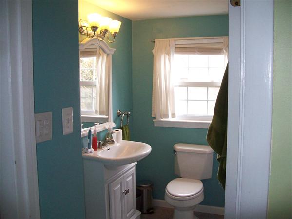 18 Embury Street Springfield, MA 01109 - Photo 11 of 14 a bathroom with a toilet a sink a window and mirror