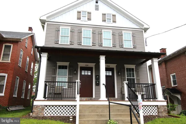 a view of a brick house with large windows
