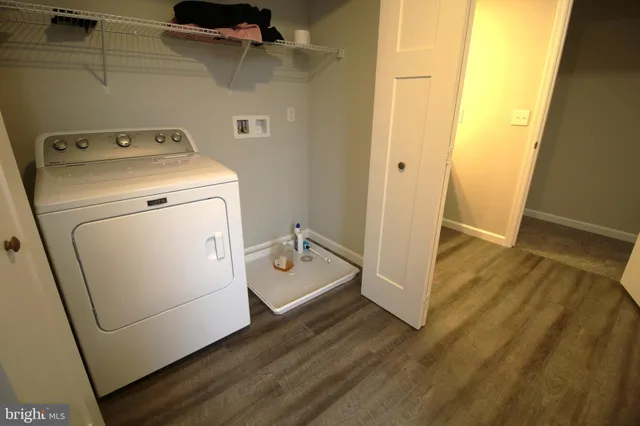 a view of a storage and utility room with a washer dryer