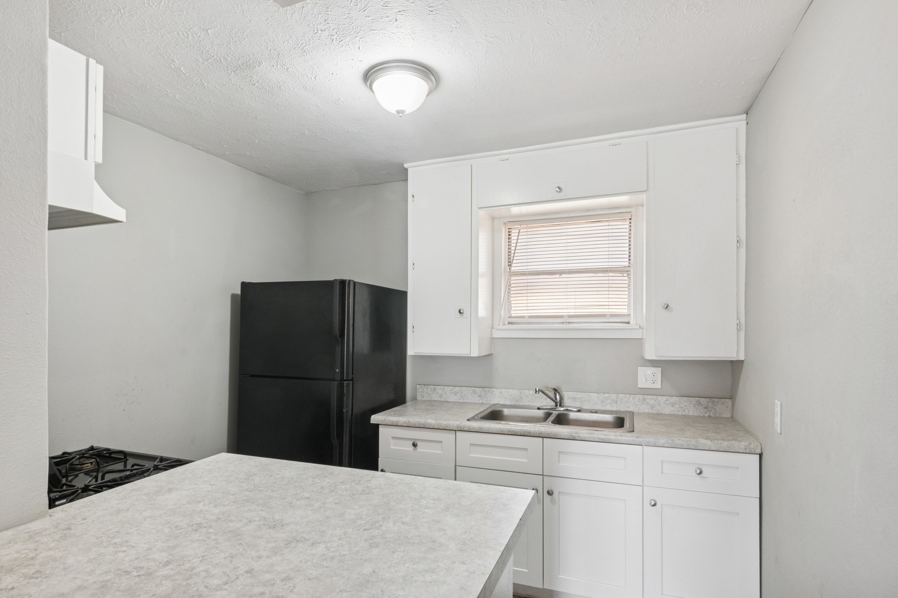 3631 North MacGregor Way, Unit 7 Houston, TX 77004 - Photo 11 of 12 a kitchen with a refrigerator and a sink