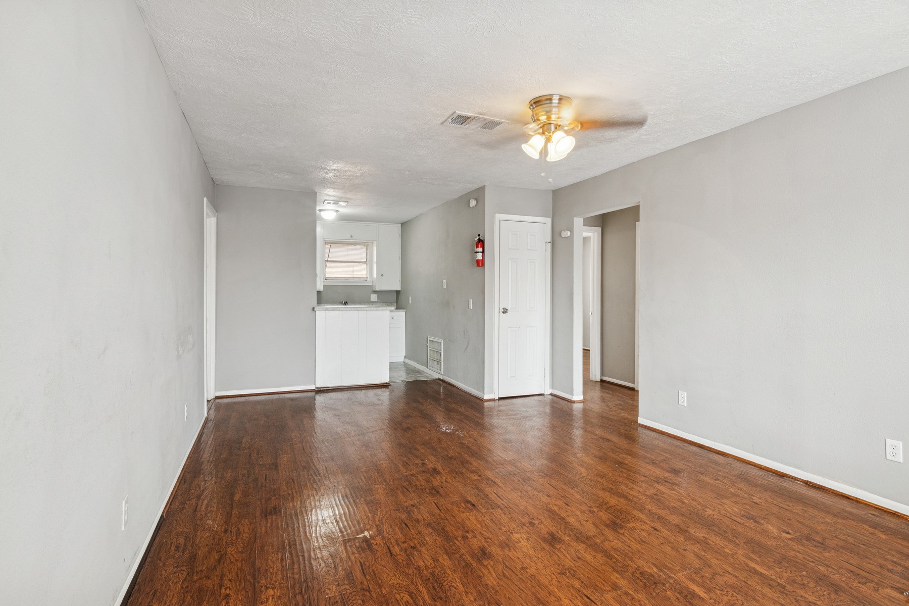 3631 North MacGregor Way, Unit 7 Houston, TX 77004 - Photo 6 of 12 a view of an empty room with wooden floor and a window