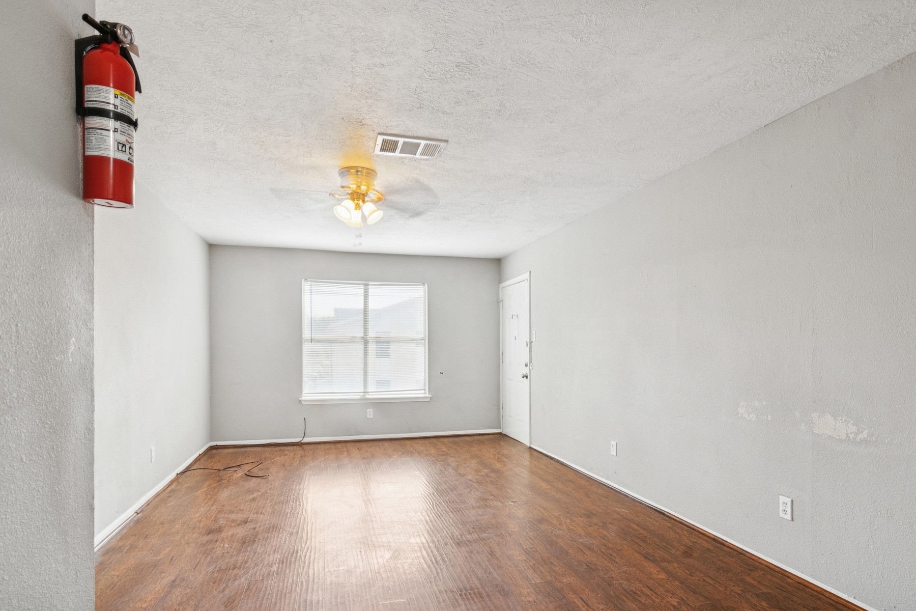 3631 North MacGregor Way, Unit 7 Houston, TX 77004 - Photo 7 of 12 an empty room with a window and cabinet