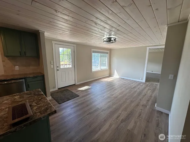 wooden floor in an empty room with a fireplace