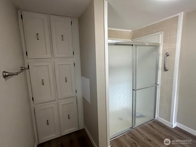 a view of walk in closet with empty racks