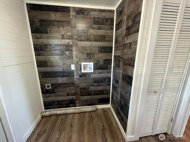 a view of an empty room and wooden floor