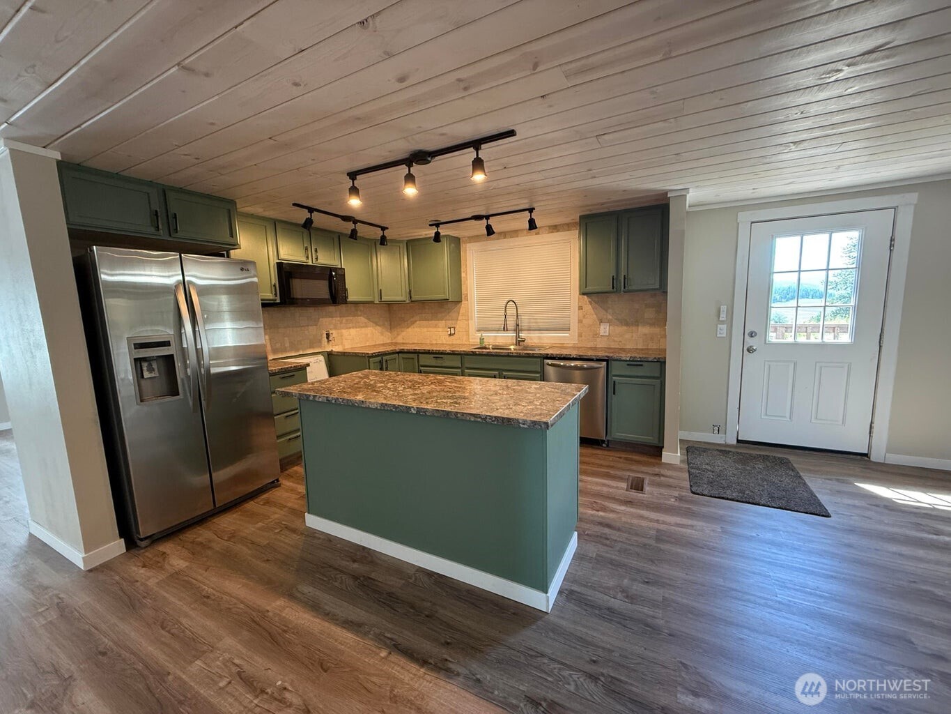 708 North Ridge Street Chewelah, WA 99109 - Photo 10 of 29 a kitchen with stainless steel appliances granite countertop a sink a stove a refrigerator and a microwave