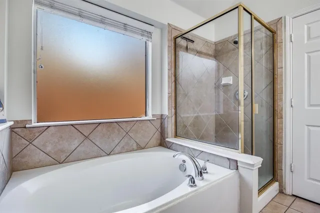 a bathroom with a bathtub and a shower
