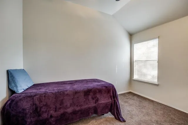 a bedroom with a bed and a chair