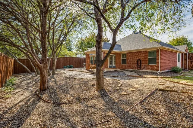a tree in front of a white house
