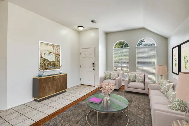 a living room with furniture and a large window