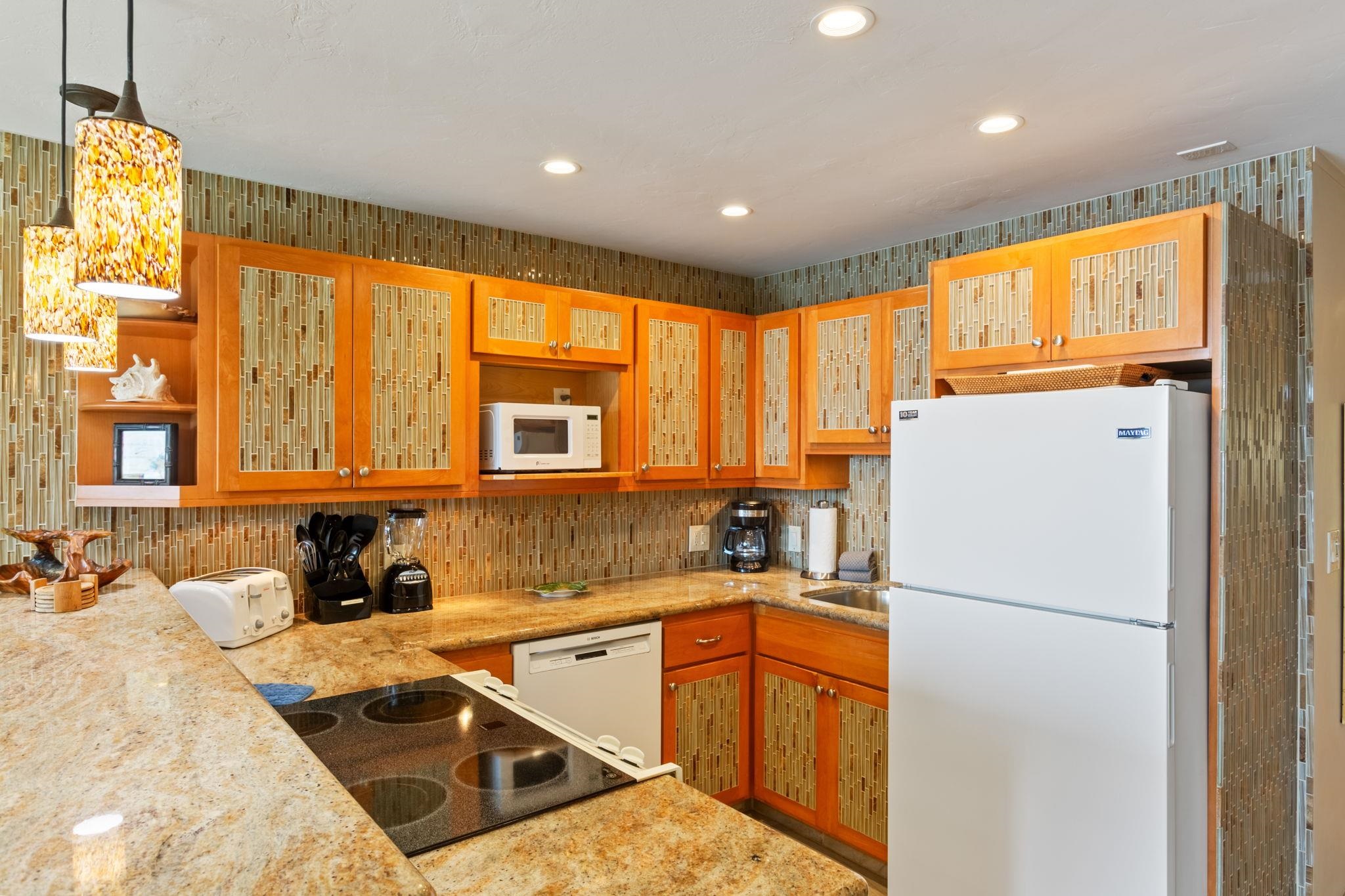 5255 Lower Honoapiilani Road, Unit 119 Lahaina, HI 96761 - Photo 4 of 22 a kitchen with a refrigerator a sink and a cabinets