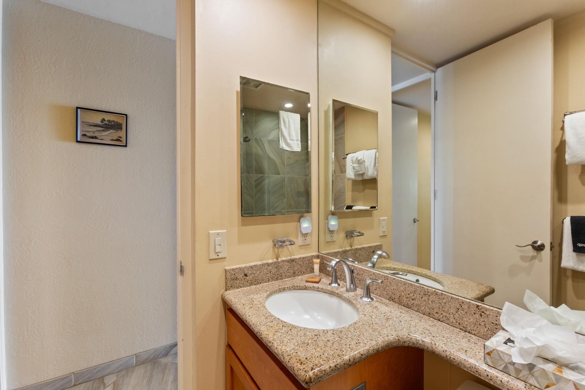 5255 Lower Honoapiilani Road, Unit 119 Lahaina, HI 96761 - Photo 8 of 22 a bathroom with a granite countertop sink and a mirror